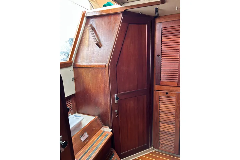 Slide: The Image of Interior of 1988 Catalina 34 sailboat with wooden cabinetry and steps. - 41