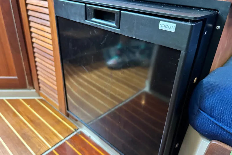 Slide: The Image of Norcold refrigerator in 1988 Catalina 34 yacht interior with wooden flooring. - 27