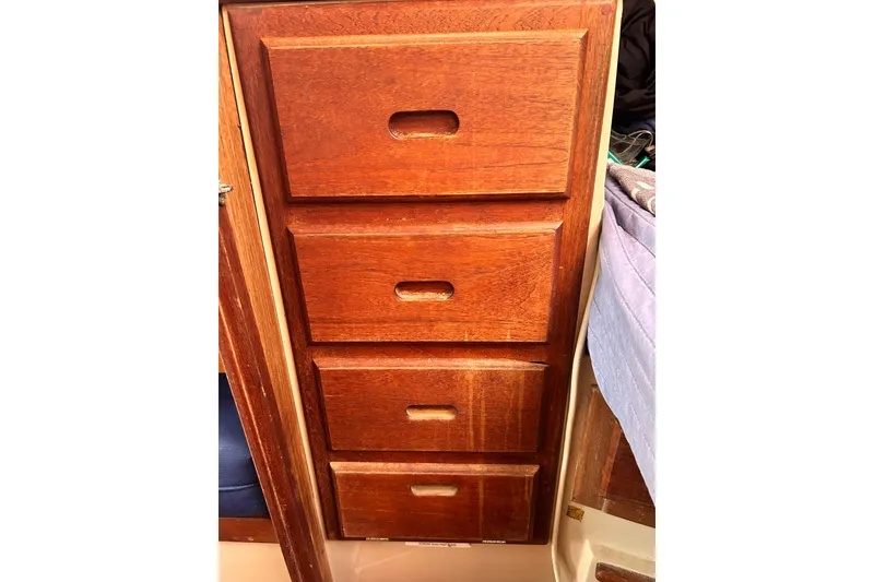 Slide: The Image of Wooden drawers inside a 1988 Catalina 34 sailboat cabin. - 31