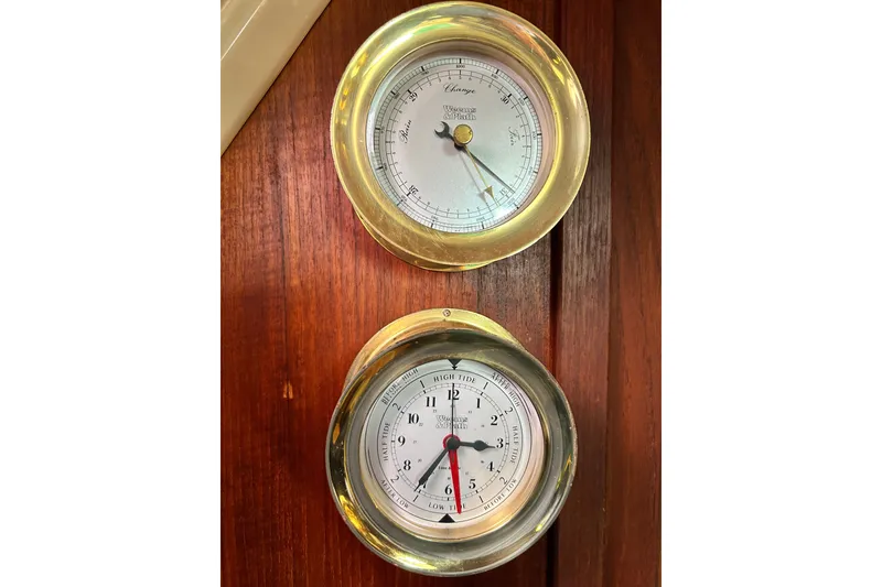 Slide: The Image of Brass barometer and tide clock on 1988 Catalina 34 yacht's wooden interior. - 20