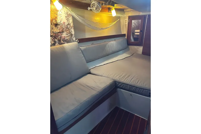 Slide: The Image of Interior of a 1988 Catalina 34 with cozy cushions and a hammock. - 35