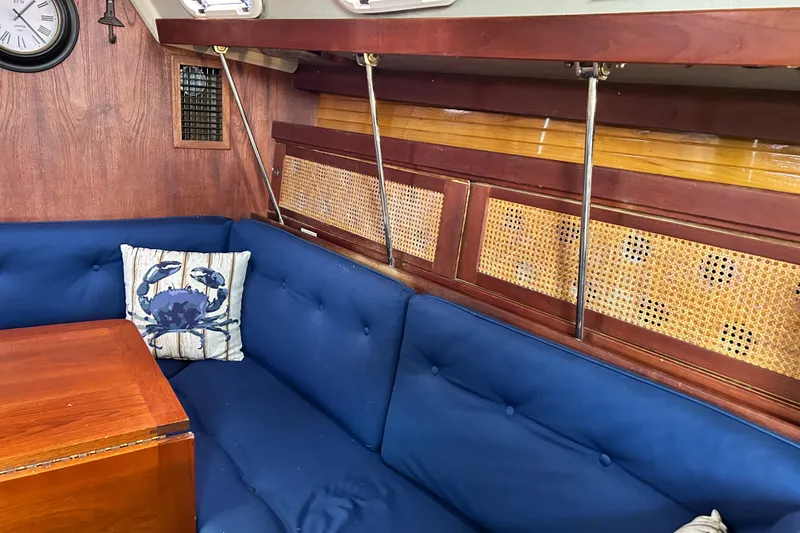 Slide: The Image of Interior of a 1988 Catalina 34 sailboat with blue seating and nautical decor. - 13