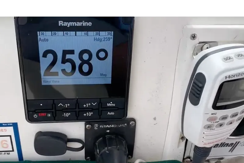Slide: The Image of Raymarine navigation display and radio on 1988 Catalina 34 sailboat dashboard. - 48