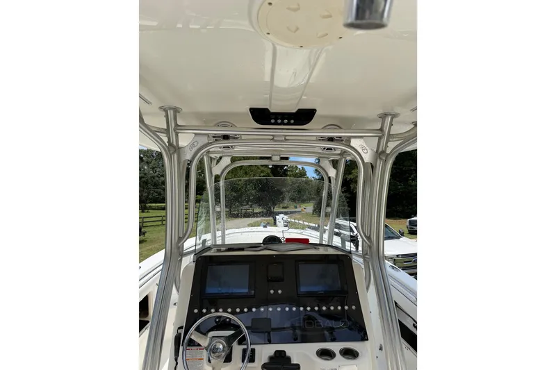 Slide: The Image of 2007 Robalo R300 Center Console boat dashboard with navigation screens and steering wheel. - 7