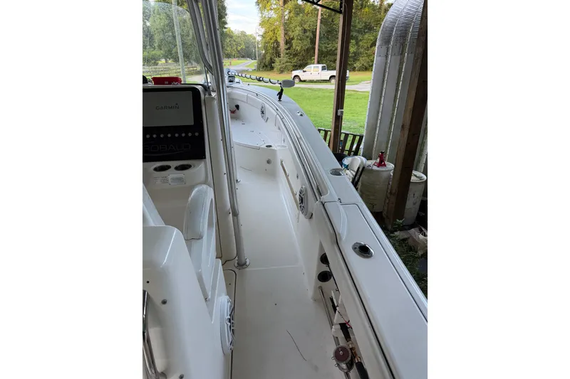 Slide: The Image of 2007 Robalo R300 Center Console boat interior with Garmin equipment, parked outdoors. - 8