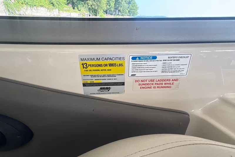 Slide: The Image of Boat capacity and safety labels on a 2005 Azure AZ240 interior. - 15