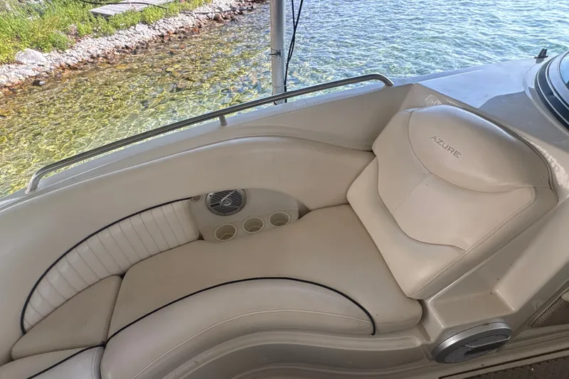 Slide: The Image of Luxurious seating on a 2005 Azure AZ240 boat, near clear water and rocky shore. - 18