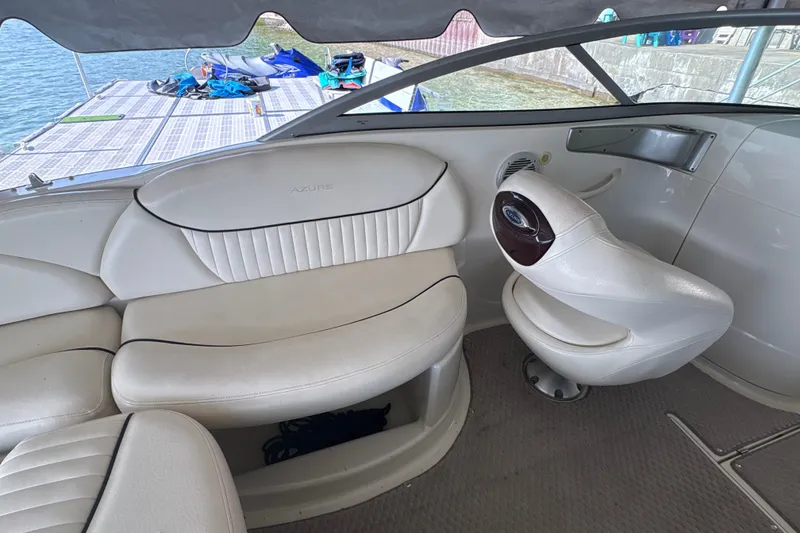 Slide: The Image of Interior of a 2005 Azure AZ240 boat with white seating and helm. - 11