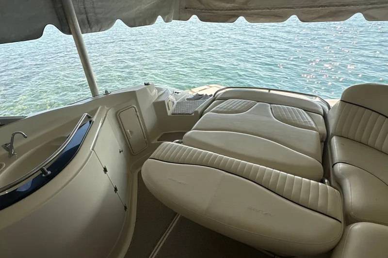 Slide: The Image of Luxury seating on a 2005 Azure AZ240 boat overlooking serene water. - 5