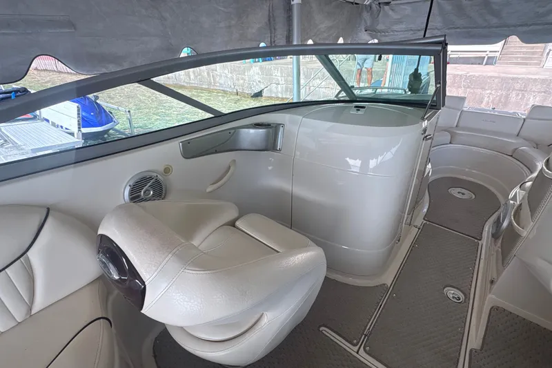 Slide: The Image of Interior of a 2005 Azure AZ240 boat with white seating and dashboard. - 10