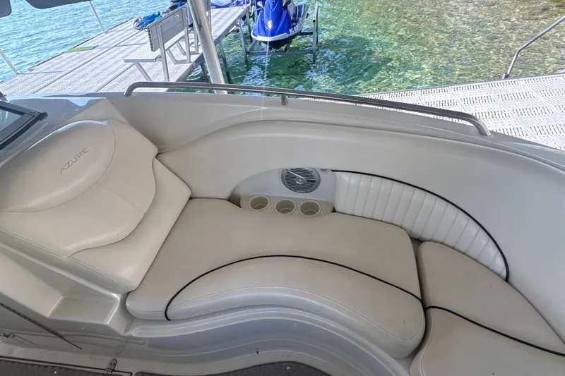Slide: The Image of Luxury seating on a 2005 Azure AZ240 boat, docked by clear water. - 19