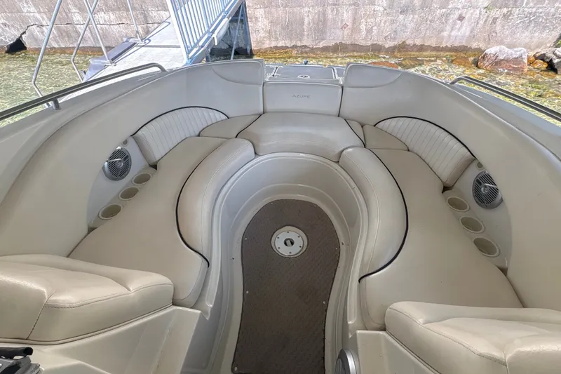 Slide: The Image of Interior of 2005 Azure AZ240 boat with beige seating and cup holders. - 16