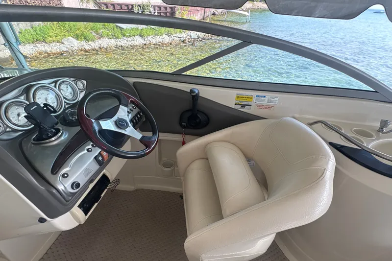 Slide: The Image of Interior of a 2005 Azure AZ240 boat with steering wheel and dashboard controls. - 13