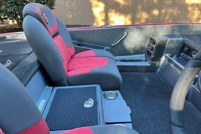 Slide: The Image of 2018 Triton 189 TrX boat interior with red and gray seating and storage compartments. - 12