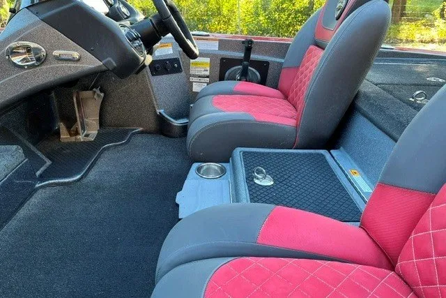 Slide: The Image of 2018 Triton 189 TrX boat interior with red and gray seating and steering console. - 16