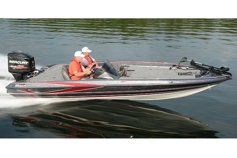 Slide: The Image of Manufacturer Provided Image: 2018 Triton 189 TrX bass boat speeding on water with two passengers. - 25
