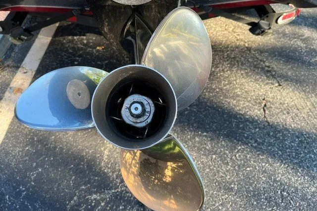 Slide: The Image of 2018 Triton 189 TrX boat propeller on asphalt surface. - 14