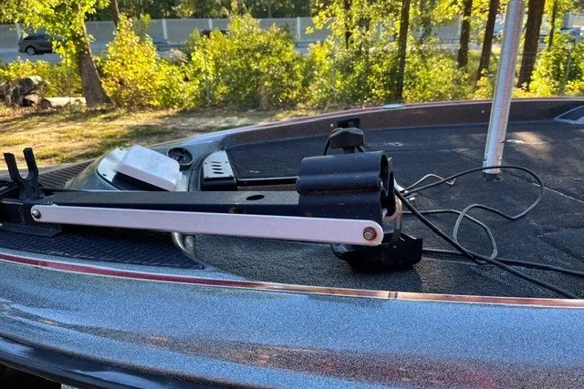 Slide: The Image of 2018 Triton 189 TrX boat deck with mounted equipment, surrounded by trees. - 17