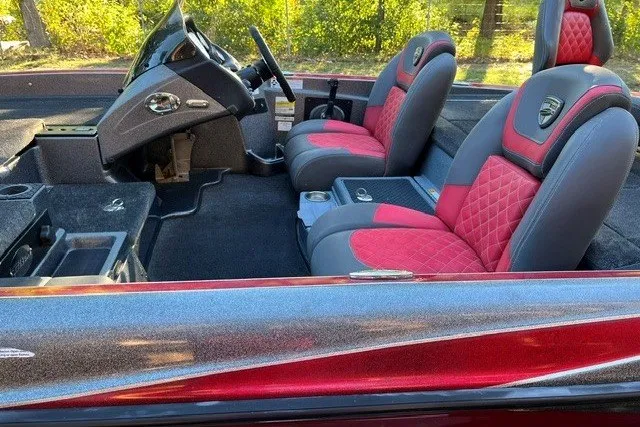Slide: The Image of 2018 Triton 189 TrX boat interior with red and gray seats, steering console visible. - 21