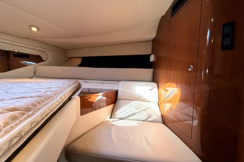 Slide: The Image of Interior of 2006 Regal Commodore 3760 IO yacht with cozy seating and wooden cabinetry. - 21