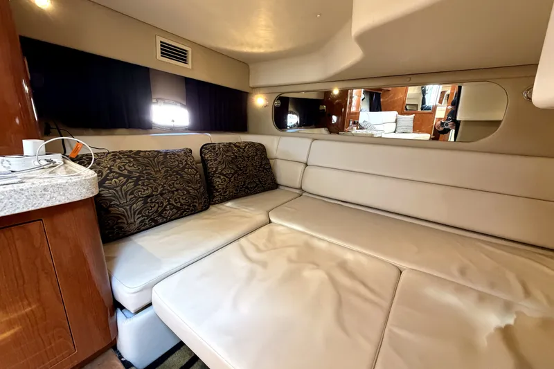 Slide: The Image of Interior of 2006 Regal Commodore 3760 IO yacht with beige seating and decorative cushions. - 23