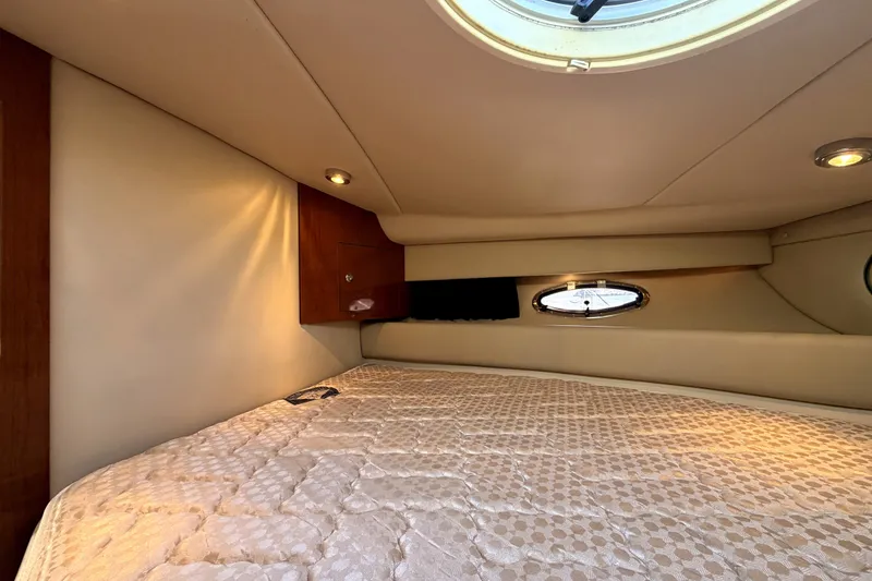 Slide: The Image of 2006 Regal Commodore 3760 IO cabin interior with bed and porthole windows. - 22
