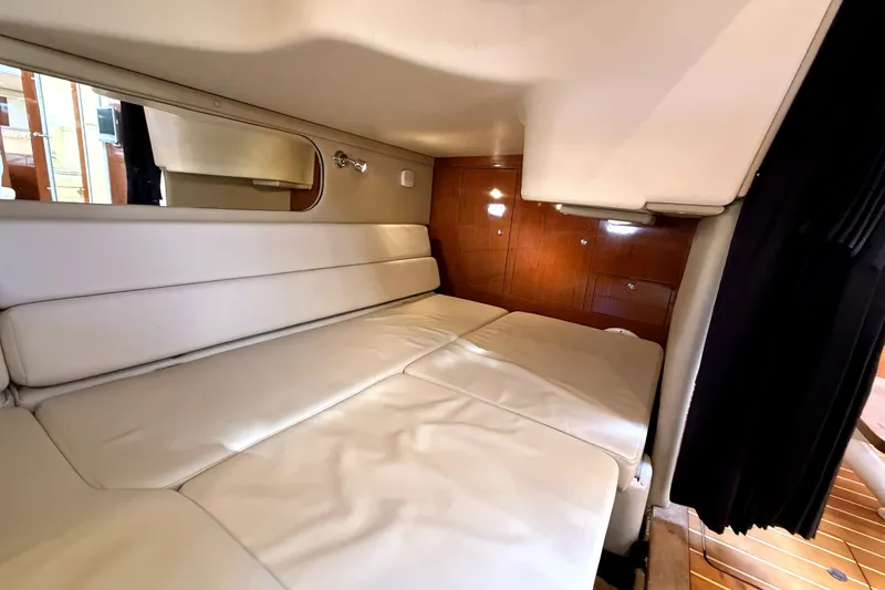Slide: The Image of Interior cabin of 2006 Regal Commodore 3760 IO with white seating and wooden accents. - 24