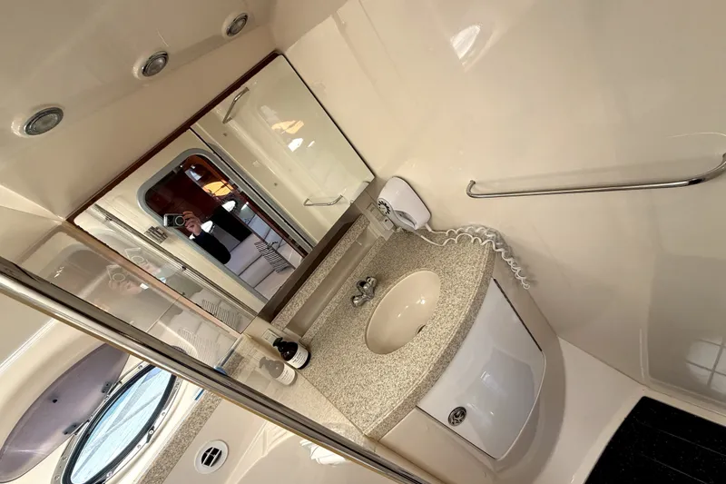 Slide: The Image of Bathroom interior of 2006 Regal Commodore 3760 IO yacht, featuring sink and mirror. - 25