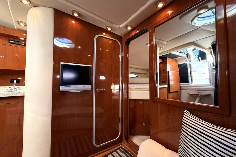 Slide: The Image of Luxurious interior of 2006 Regal Commodore 3760 IO yacht with wood finishes and modern amenities. - 18