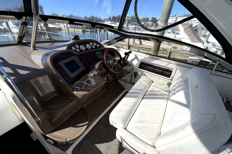 Slide: The Image of 2006 Regal Commodore 3760 IO boat cockpit with steering wheel and control panel. - 11