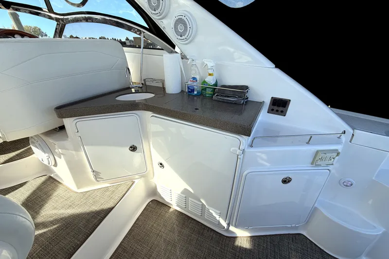 Slide: The Image of 2006 Regal Commodore 3760 IO boat interior with kitchenette and storage cabinets. - 5