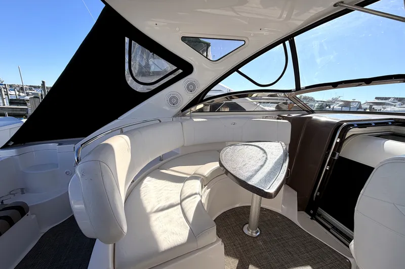 Slide: The Image of 2006 Regal Commodore 3760 IO boat interior with white seating and table. - 9