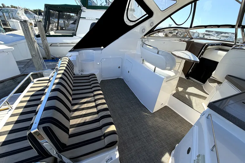 Slide: The Image of 2006 Regal Commodore 3760 IO boat interior with striped seating and helm station. - 3