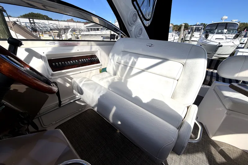 Slide: The Image of Interior of 2006 Regal Commodore 3760 IO boat with white seating and control panel. - 12