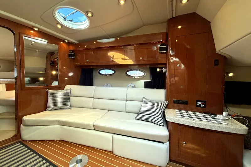 Slide: The Image of Luxurious interior of 2006 Regal Commodore 3760 IO yacht with plush seating and wood finishes. - 16