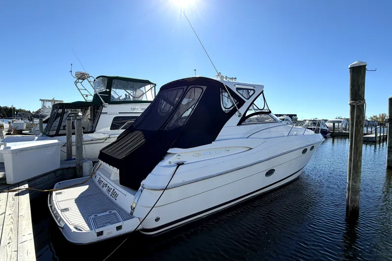Slide: The Image of 2006 Regal Commodore 3760 IO boat docked in sunny marina setting. - 1