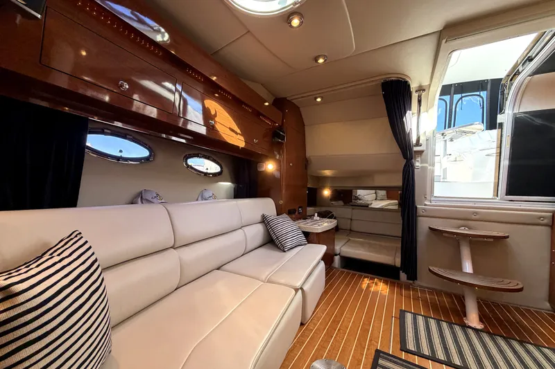 Slide: The Image of Luxurious interior of 2006 Regal Commodore 3760 IO yacht with plush seating and wooden accents. - 19