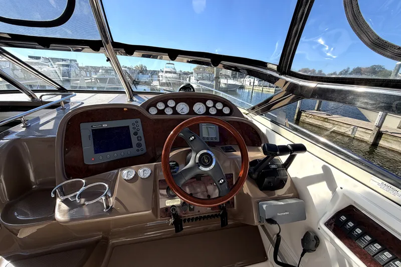 Slide: The Image of Cockpit of 2006 Regal Commodore 3760 IO boat with steering wheel and navigation controls. - 13