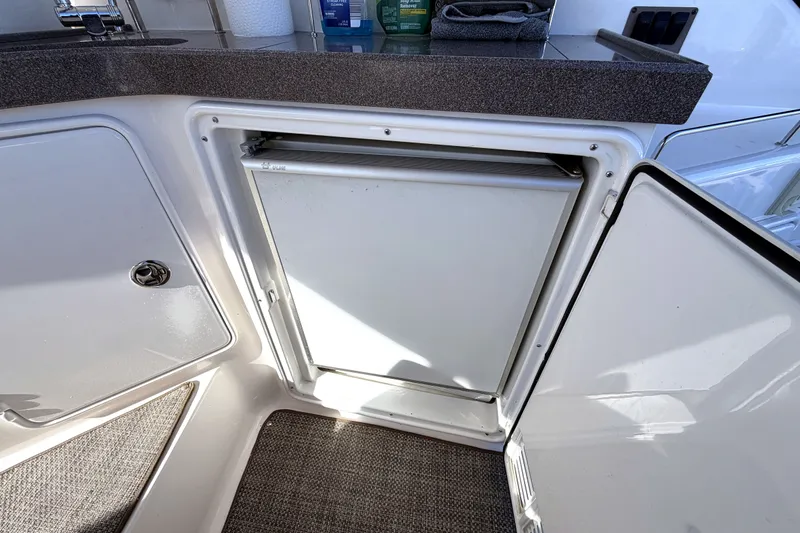 Slide: The Image of Open mini fridge on 2006 Regal Commodore 3760 IO boat, with countertop above. - 6