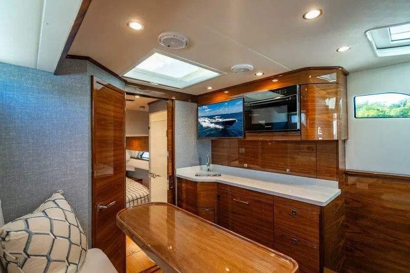 Slide: The Image of Luxurious interior of 2025 Valhalla V-55 yacht with modern wood finishes and skylight. - 9