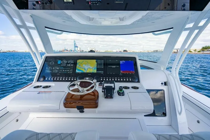 Slide: The Image of Cockpit of 2025 Valhalla V-55 boat with advanced navigation displays on open water. - 8