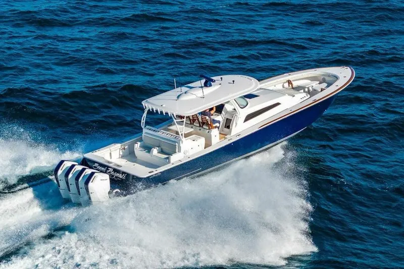 Slide: The Image of 2025 Valhalla V-55 boat cruising on open ocean with powerful engines. - 2