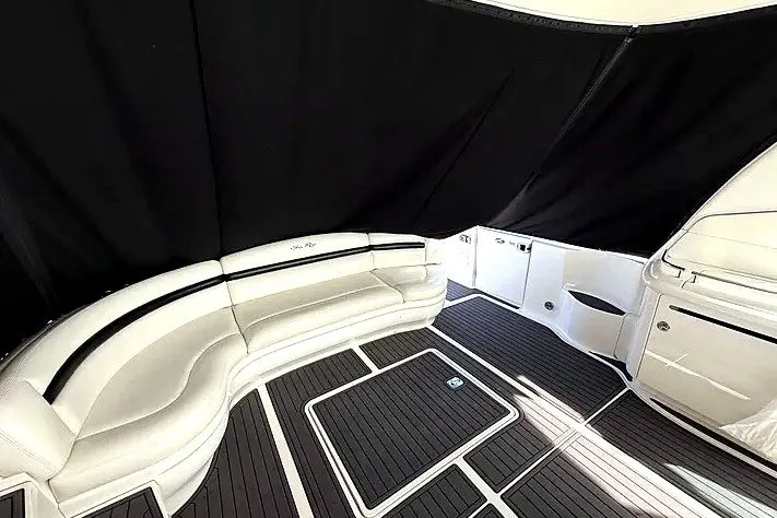 Slide: The Image of 2003 Sea Ray 500 Sundancer interior with white seating and dark flooring. - 10