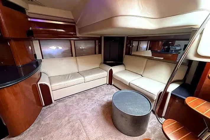 Slide: The Image of Luxurious interior of a 2003 Sea Ray 500 Sundancer yacht with beige seating and modern decor. - 13