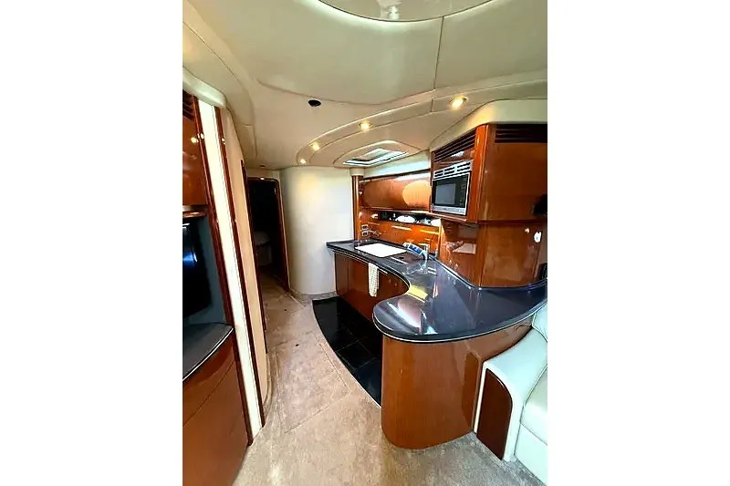 Slide: The Image of Luxurious interior of a 2003 Sea Ray 500 Sundancer yacht with modern kitchen amenities. - 18