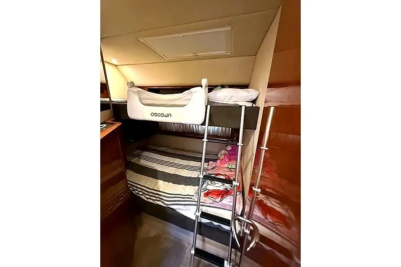 Slide: The Image of Interior cabin of 2003 Sea Ray 500 Sundancer with bunk beds and ladder. - 27