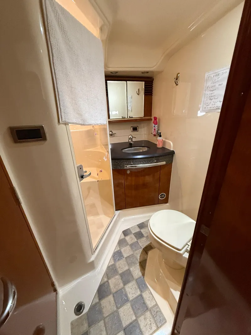 Slide: The Image of Bathroom interior of 2003 Sea Ray 500 Sundancer yacht, featuring sink and toilet. - 29