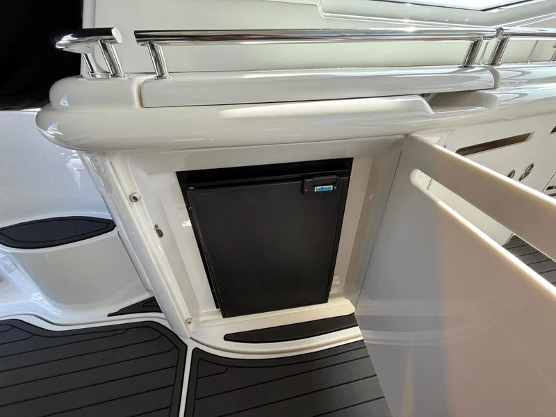Slide: The Image of 2003 Sea Ray 500 Sundancer yacht interior with built-in mini fridge and sleek design. - 11