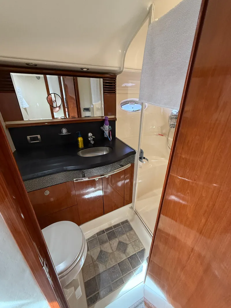 Slide: The Image of Luxurious bathroom in 2003 Sea Ray 500 Sundancer yacht with wood accents and modern fixtures. - 26