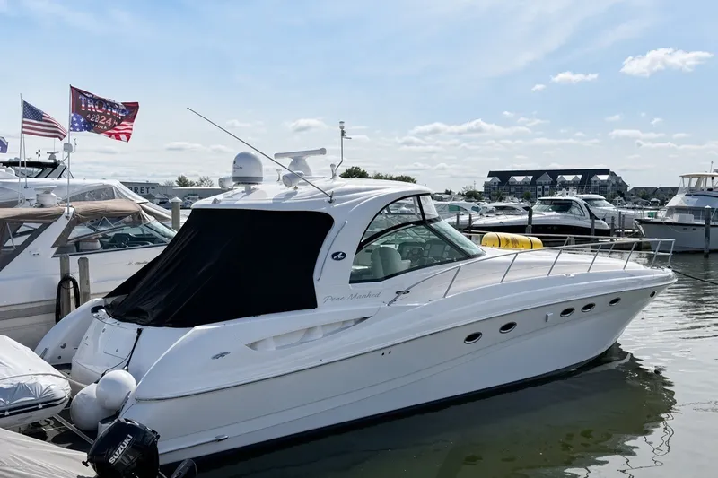 Slide: The Image of 2003 Sea Ray 500 Sundancer yacht docked at marina under clear sky. - 3